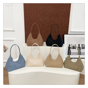 Collection of minimalist hobo shoulder bags in six colors displayed on a podium