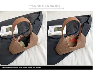 Detail of felt shoulder bag interior showing large capacity for phone and cosmetics