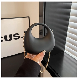 Borsa a mano a mezzaluna nera minimalista, finitura opaca e catena dorata
