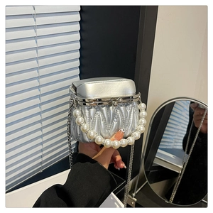 Close-up of silver pleated mini box bag with crystal rhinestones and pearl handle