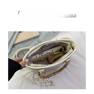 Detailed interior of a white textured tote bag showing high capacity and zip pocket