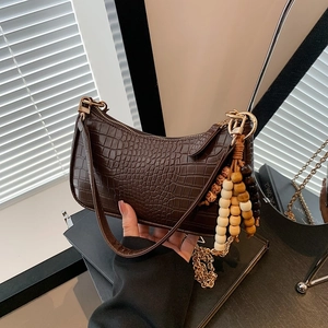 Brown crocodile pattern underarm bag with decorative wooden beads and golden hardware