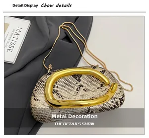 Detailed close-up of snake print box bag with gold metal link decor and chain strap
