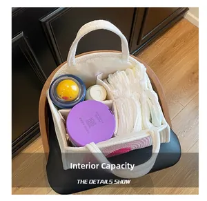 Detailed interior of a canvas nursery caddy showing compartments for baby essentials