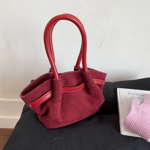 Chic burgundy suede handbag with red leather handles and minimalist pleated tote design