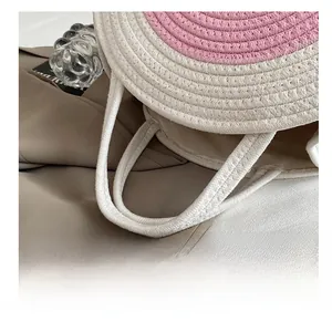 Close-up of pink and cream woven cotton rope handbag showing texture and sturdy handles
