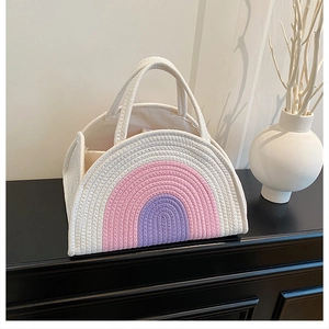 Detail of colorful rainbow woven cotton rope handbag with white pink and purple stripes