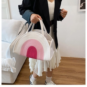 Detail of the high-density woven cotton texture and pink rainbow stitching on the bag