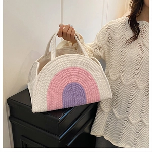 Detail of handmade rainbow cotton rope woven bag featuring a textured semi-circle design