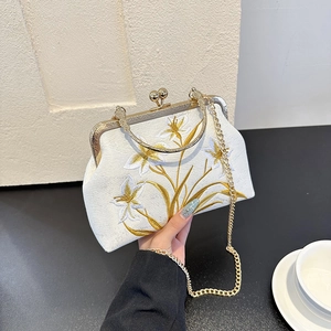 Vintage white embroidered evening bag with gold floral patterns and metal chain strap