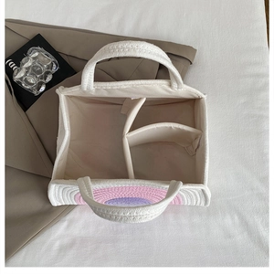 Top view of woven tote bag showing internal three-compartment structure and rainbow patterns