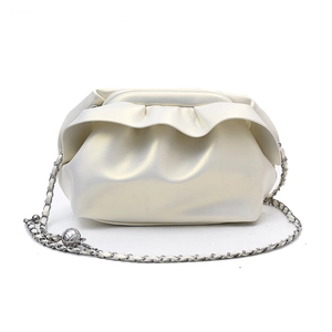 Creamy white pleated cloud bag with silver chain strap shown on a clean white background