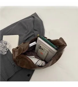 Macro shot of spacious interior for vintage brown bucket bag showing daily essentials