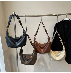 Detail of vintage bucket bags in four colors with adjustable gold buckles and wide straps