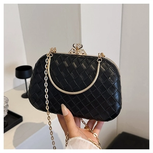 Detail showing black woven pattern evening clutch with gold metal frame and crystal clasp
