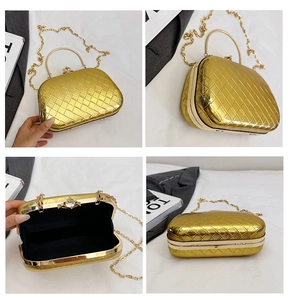 Detail of gold quilted evening clutch with diamond clasp, chain, and inner lining