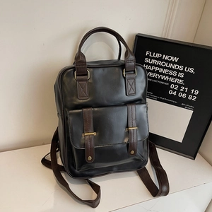Sac à dos rétro noir avec poignée en cuir marron et boucle décorative en intérieur