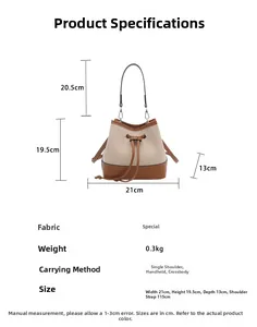 Detail view of canvas bucket bag dimensions with brown leather trim and strap measurements