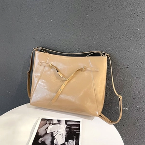 Minimalist khaki large capacity leather tote bag with metallic buckle in studio setting