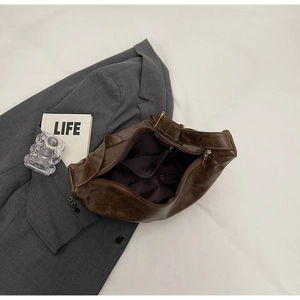 Detailed interior of a brown leather tote bag showing organized pockets and large capacity