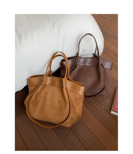 Detail of vintage canvas tote bags featuring contrasting textures and large capacity
