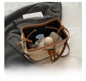 Interior view showing the storage capacity and canvas-leather texture of the bucket bag