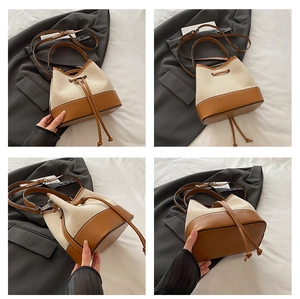 Detail view of canvas bucket bag showing drawstring closure and leather patchwork