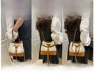 Three-way carry view of a canvas bucket bag with brown leather trim and drawstring detail