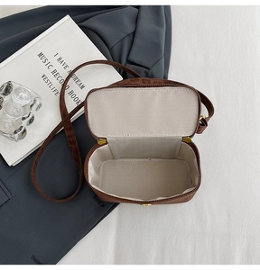 Detail of leopard print crossbody box bag showing inner lining and metal hardware details