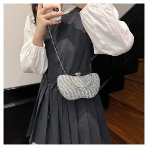 Selfie allo specchio che mostra il motivo di strass ondulati e la catena della pochette