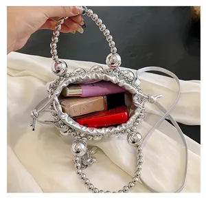 Interior view of silver beaded bag showing drawstring closure and daily essentials storage