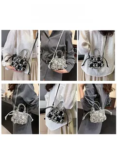 Detail of beaded mini bucket bag showing pearl handle and versatile carrying styles