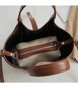 Detailed interior of the canvas tote bag showing the zipper pouch and metal buckle