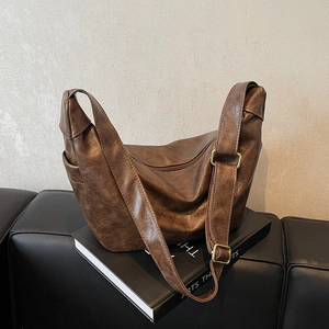 Brown vintage hobo shoulder bag in pebbled faux leather with gold buckle detail