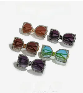 Macro detail of oversized square sunglasses featuring hand-set crystals and tinted lenses