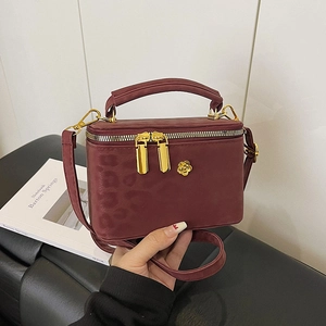 Deep red leopard embossed mini box bag with gold floral hardware and crossbody strap