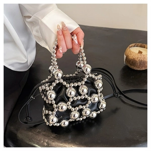 Detail of black leather drawstring bag with silver metallic bead mesh and beaded handle