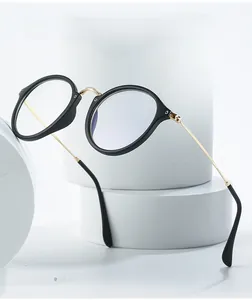 Close-up of retro round anti-blue light glasses with black frames and gold metal temples