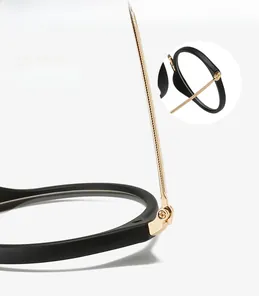 Detail view of durable gold metal hinge on matte black fashion glasses frame