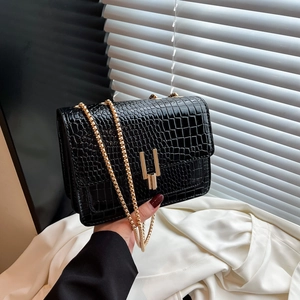 Chic black crocodile pattern crossbody bag with golden H-buckle and chain strap