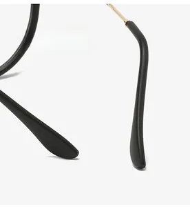 Close-up of ergonomic curved black temple tips with elegant gold metal hinge detail