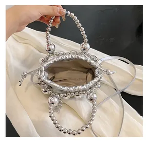 Top view of silver beaded bucket bag showing interior space and chevron pattern lining