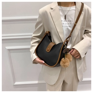 Classic black and brown leather hobo bag for women with stylish plush ball pendant