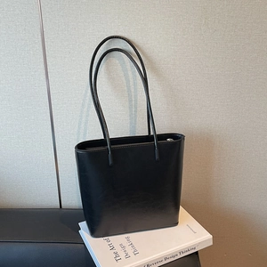 Minimalist black leather tote bag with long shoulder straps for autumn winter commute