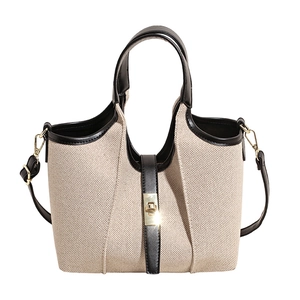 Canvas and leather bucket bag with top handle, gold lock and adjustable shoulder strap