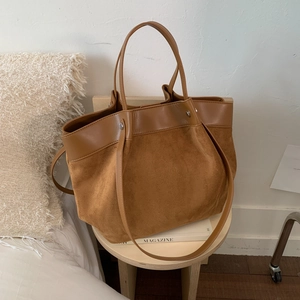 Retro brown canvas leather tote bag with large capacity in minimalist home setting