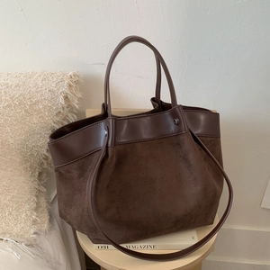 Retro canvas and leather patchwork tote bag in chocolate brown on a wooden side table
