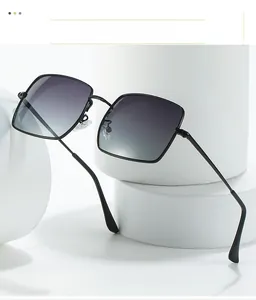 Detail of square oversized sunglasses with black metal frames and gradient grey lenses