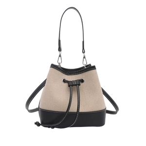 Minimalist canvas bucket bag with black leather trim and contrast stitching details