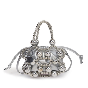 Silver beaded handbag with metallic finish and drawstring closure on white background